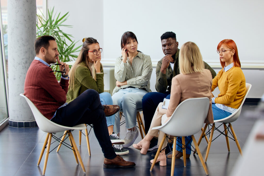 Group of people discussing different topics while seated in a contemporary setting